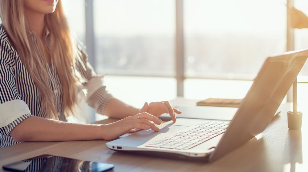 Woman at home on laptop in a stress-free environment taking an exam