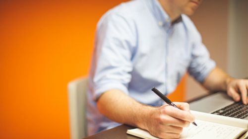 Man at laptop doing on-screen question authoring