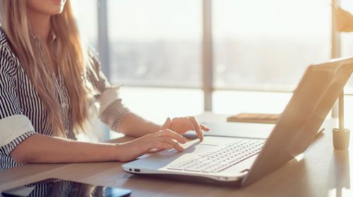 Woman at home on laptop in a stress-free environment taking an exam