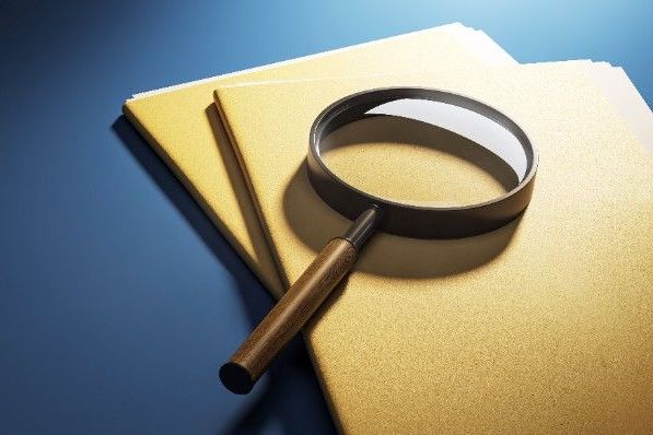 Folders and magnifying glass representing Market Research Society examinations