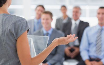 Woman in business attire presenting at a training event