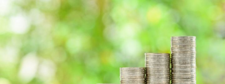 Money stacking up on a table to illustrate the work of the Pensions Management Institute, who use TestReach for online examination delivery.